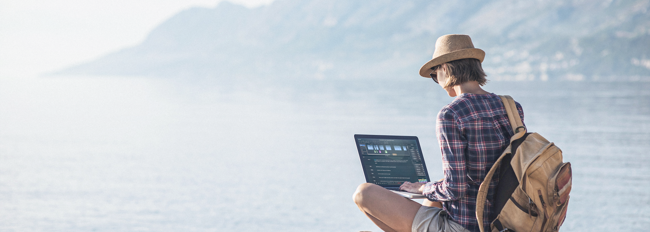 Relaxed girl with hat and daypack a pictures remote lake scenery Editing Audio in Hindenburg Pro 2 Darkomode on a Laptop