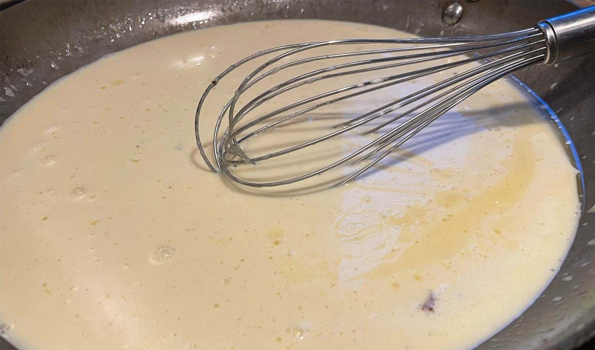 Iron Pan with Cream and Parmesan Sauce for Fettuccine Alfredo to illustrate the Love for the craftsmanship needed in Audio Editing